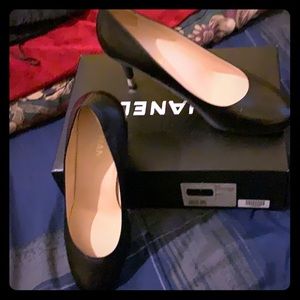 Channel black leather pumps.